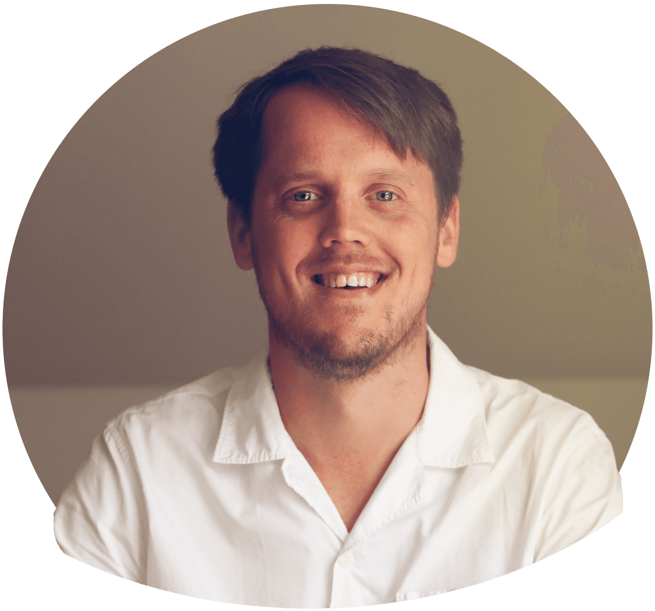 Tommy F med kort mellanblont hår i vit skjorta. Foto.